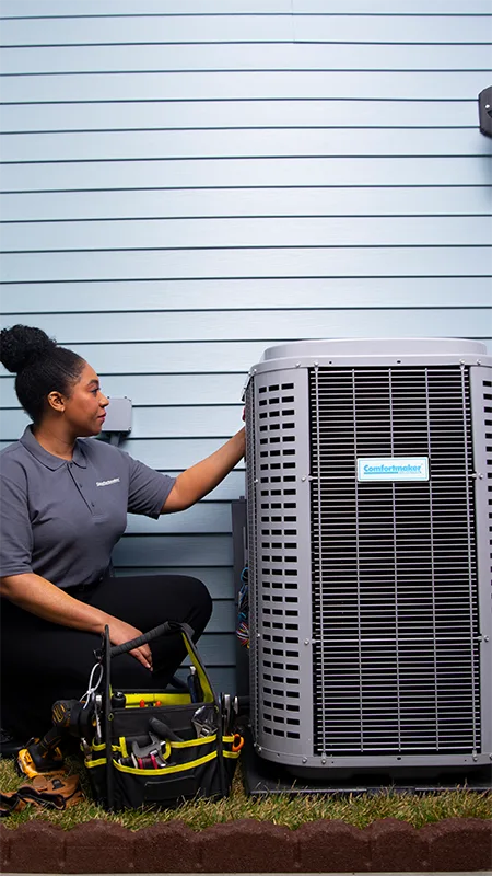 female technician repairing an air conditioner | Sunshine Heating and Air Conditioning
